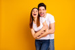 © deagreez - Portrait of his he her she two nice-looking lovely sweet attractive cheerful cheery positive people cuddling laughter isolated over vivid shine bright yellow background