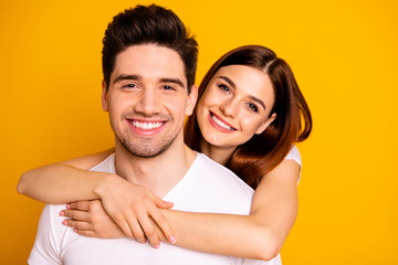 Close-up portrait of his he her she two nice lovely charming attractive cheerful positive people cuddling spending time isolated over vivid shine bright yellow background