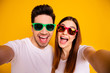 © deagreez - Self-portrait of his he her she two nice attractive lovely charming stylish trendy cheerful cheery glad people having fun isolated over vivid shine bright yellow background