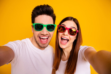 Self-portrait of his he her she two nice attractive lovely charming stylish trendy cheerful cheery glad people having fun isolated over vivid shine bright yellow background