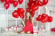 Valentine's Day. Beautiful girl red with heart balloons. Girl with braces. Orthodontics treatment. 