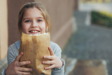 little girl holding popcorn