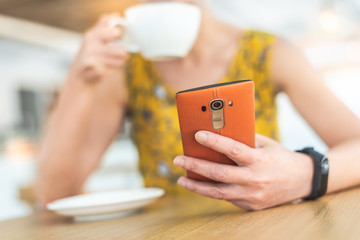 Wall Mural - woman using cellphone at a coffee shop