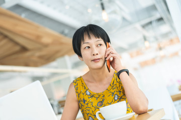 Wall Mural - woman listen at mobile phone and working