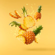 Flying in air fresh ripe whole and cut baby Pineapple with slices and leaves