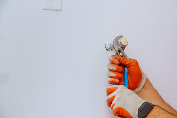 Wall Mural - Plumber hands using wrench at work repair plumbing.