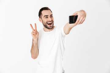 Wall Mural - Handsome cheerful man wearing blank t-shirt