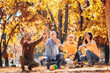 © Mediteraneo - Multl generation family in autumn park having fun