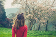 © LoloStock - Young woman looking at cherry blossom
