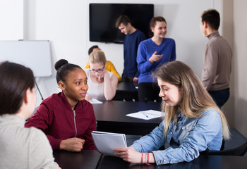 Wall Mural - Emotional and female students having conversation at recess