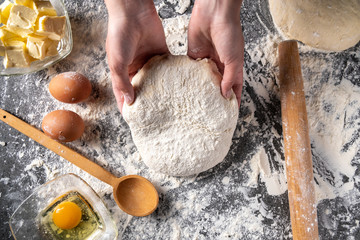 Making dough by female hands at bakery