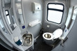 Toilet in Ukrainian Railways First Class sleeping carriage of a passenger train – toilet-bowl, washbasin, mirrors and toilet paper box