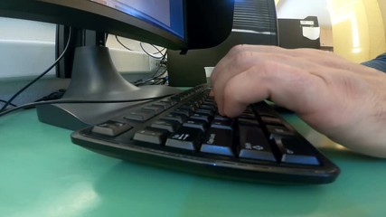 Hacker developer hands fast typing malicious code on computer keyboard in the office