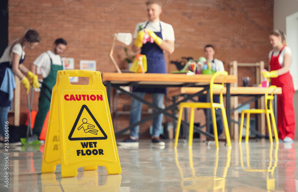 Sign board on floor in office during cleaning