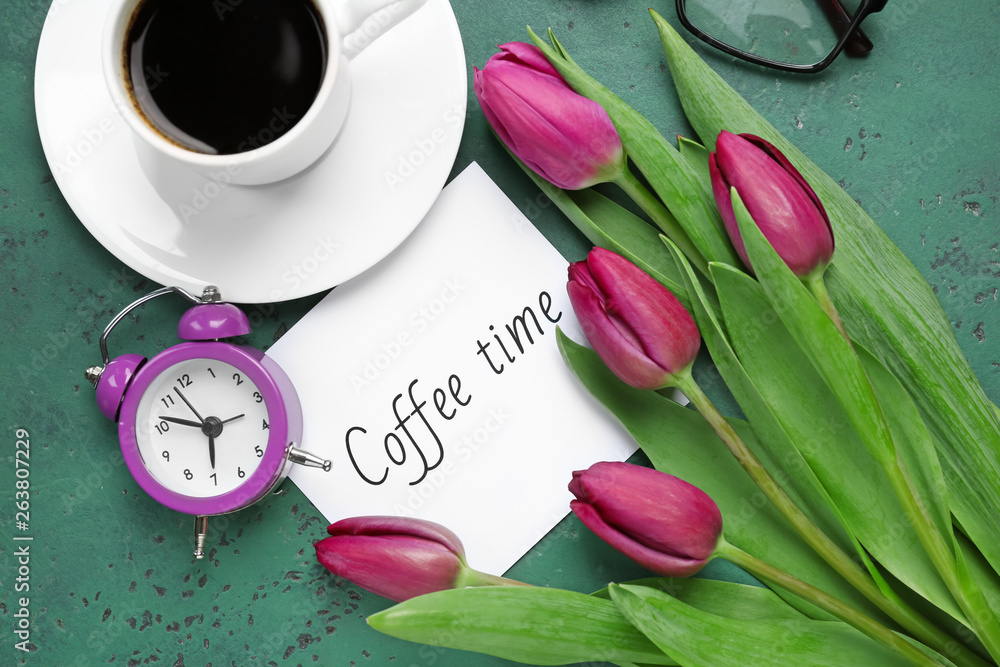 Composition with beautiful tulips, cup of coffee and clock on color background