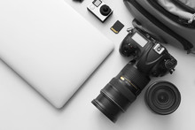 Modern Equipment Of Professional Photographer With Laptop On Light Background