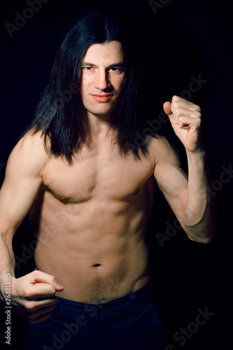Handsome Young Man With Long Hair Naked Torso On Black Background