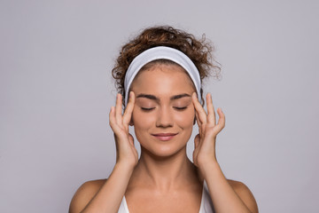 A portrait of a young woman in a studio, beauty and skin care.