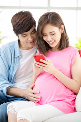 Canvas Print - Pregnant couple use smart phone