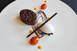 © Trinette Reed/Stocksy - Gourmet dessert with chocolate cake and kumquats