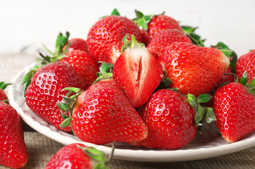 Wall Mural - Fresh strawberries in plate on wood