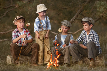 Wall Mural - Group of friends are resting by the fire in the forest