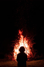 Silhouette Of A Man Against The Background Of A Fire Flame