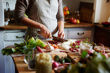 Woman Chopping Vegetables While Cooking