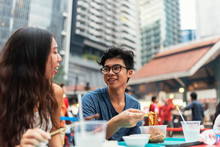 Young Asian Couple Having Dinner In One Hawker