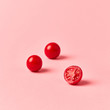 © Yaroslav Danylchenko/Stocksy - Close-up ripe red cherry tomatoes with half of tomato on a paste
