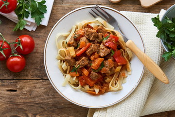 Wall Mural - Lagman noodles with beef meat and vegetables in a white bowl