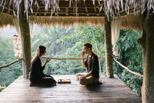 Couple Having Tea On Tropical Terrace