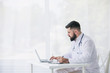 © D'Action Images - Doctor is working with documents and laptop in his medical office