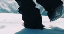 Close Up Of Snowboarder Boots Walking In Soft Fresh Powder Snow