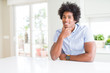 © Krakenimages.com - African American business man looking confident at the camera with smile with crossed arms and hand raised on chin. Thinking positive.