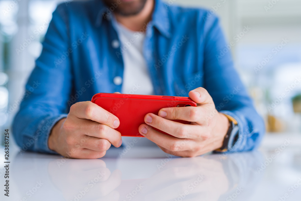 Close up of man hands using smartphone and smiling