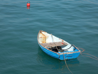 Empty row boat at anchor