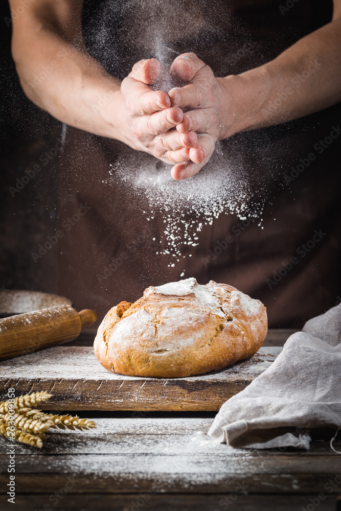 Baker cooking bread. Man slaps flour over the dough. Man's hands Making bread - obrazy, fototapety, plakaty 