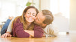 © Krakenimages.com - Beautiful romantic couple sitting together on the floor kissing in love at home