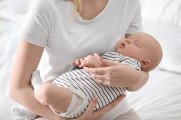 Sticker - Mother holding her little baby on light background