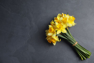 Canvas Print - Bouquet of daffodils on dark background, top view with space for text. Fresh spring flowers