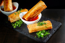 Fried Spring Rolls On Black Slate Decorated With Greens-2.