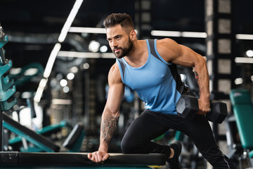 Canvas Print - Millennial muscular man doing exercises with dumbbells