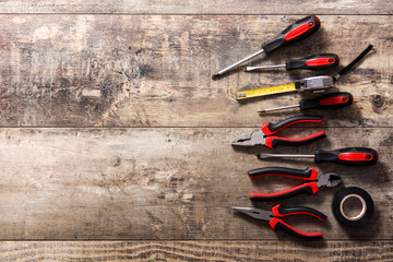 Building tools repair set on wooden background. Top view. Copyspace