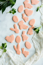 Pink Sugar Cookies On Marble Background With Lace And Greenery