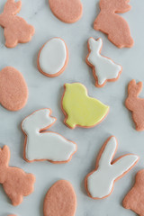 Pink Bunny, Egg, and Duck Sugar Cookies with Royal Icing on White Marble Background