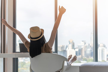 Poster - Work-life balance, work and travel lifestyle relaxation of young freelancer Asian working woman celebrating healthy living happily resting in comfort luxurious hotel guest room with peace of mind