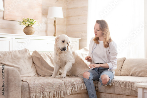 Young Handsome Woman Teaches His Big Dog To The Rules Sitting On