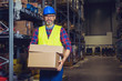 © zorandim75 - Warehouse worker placing cardboard boxes