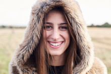 Portrait Of Happy Young Woman Wearing Fur Hood